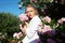 Beauty woman with bunch rose flowers.