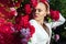 Beauty woman with bunch rose flowers