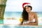 Beauty woman with Christmas hat in swimming pool