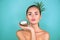 Beauty Woman with coconut Portrait. Spa model girl holding coco nut. Pretty young brunette woman face. Skin care