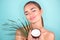 Beauty Woman with coconut Portrait. Spa model girl holding coco nut. Pretty young brunette woman face. Skin care