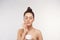 Beauty Woman Concept. Skin care. Young model with Soft skin holding cosmetic cream. Portrait of female applying moisturizing cream