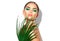 Beauty woman with natural green palm leaf. Portrait of model girl with perfect makeup, green eyeshadows