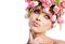 Beauty woman portrait with wreath from flowers on head over whit