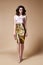 beauty woman pretty face tan skin wear silk blouse gold skirt dress long skinny body shape makeup cosmetic summer collection