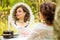 A beauty woman sitting and looking in the mirror in the forest, morning of the bride, natural beauty