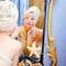 Beauty woman with towel looking at golden mirror