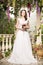 Beauty woman in white dress. Bride, wedding in garden. Brunette