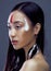 Beauty young asian girl with make up like Pocahontas, red indians woman fashion, close up beauty
