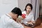 Beauty young Asian woman getting a bouquet of red roses in office on valentine`s day. Love and romance in workplace concept.