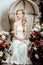 Beauty young bride alone in luxury vintage interior with a lot of flowers close up