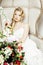 Beauty young bride alone in luxury vintage interior with a lot of flowers close up, bridal style