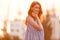 Beauty Young Ginger girl in dress posing sideways on sunset