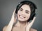 Beauty young girl hearing music with headset