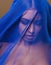 Beauty young islamic woman under veil, blue hijab on face close up, art terrorism