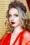 Beauty young queen long blond hair crown on her head close up and red lips