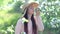 Beauty young woman enjoying apple blooming spring orchard.