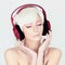 Beauty young Woman listening music on headphones