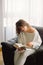 Beauty young woman is reading a book at home. Thoughtful girl reading important book