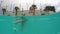 Beauty young woman swimming under water in outdoor pool