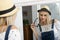 Beautyful blond woman posing with summer hat in the mirror