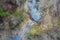 Beaver dam on forest river at early spring time, drone view. Stream, treetops, wetland. Aerial landscape