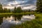 Beaver pond at Schwabacher Landing in Grand Teton national park with cloudy sky reflecting in water