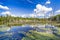 Beaver Pond with White Billowing Clouds Reflecting in the Water