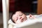 Bebe with yellow and white body lying on baby hammock