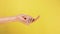 Beckoning sign. Come here. Single handed gesture. closeup. Isolated on yellow background