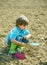 Become little farmer. Gardening activity with little kid. Spring season. Little toddler boy gardening and having fun in