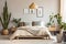 Bed with beige bedding in room with many green houseplant. Scand