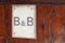 Bed and breakfast text on wooden entrance door of b&b hotel building