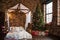 Bed with canopy valance baldachin decorated with decorative pillows with a pattern and lamps . Christmas tree with gifts loft