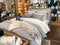 A bed with comforter, sheets, and pillows for sale at a  Pottery Barn at an indoor mall in Orlando, Florida