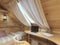 Bed and desk in the children\'s room in a log house in the attic