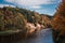 The bed of the Gauja river in Sigulda in autumn. Along the banks are trees with yellowed leaves