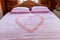 Bed room in luxury honeymoon sweet suits. Honey moon bed.Honeymoon, Wedding bed topped with rose and marigold petals.