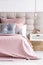 Bed with soft pink coverlet