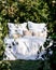 Bed with white patterned linen in the garden in the summer