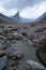 Bed of wild Weasel river in remote arctic valley on a cloudy and rainy day. Dramatic arctic landscape of Akshayuk Pass