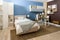 Bedclothes on bed in cozy bedroom in blue tones