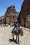 A Bedouin boy rides a donkey through the ancient ruins of Petra in Jordan.