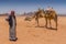 Bedouin with camels in the desert Wadi Rum, Jordan, Middle East