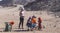 Bedouin children entertain tourists. Kids of the Sahara desert. Children-natives extort gifts from tourists