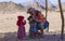 Bedouin children entertain tourists. Kids of the Sahara desert. Selfies with babies in Africa