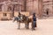 Bedouin drovers stand with their riding donkeys waiting for tourists in Petra - the capital of the Nabatean kingdom in Wadi Musa c