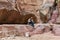 Bedouin janitor sits in a niche in the rock and rests at the canyon leading to Petra - the capital of the Nabatean kingdom in Wadi