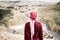 Bedouin tourist woman next to the sightseeing in Jordan. Visiter and traveler woman with original scarf.