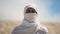 Bedouin in white clothes looking on camera, islamic religion and traditions